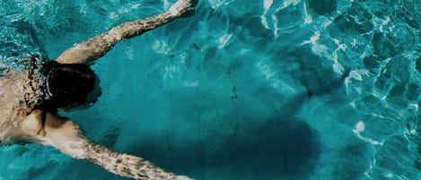 Outdoor pool, open 7:00 AM to 7:00 PM, pool loungers
