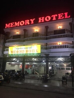 A hotel with a prominent 'MEMORY HOTEL' sign, a balcony, and a visible entrance with seating outside. - Memory Hotel (Vientiane)