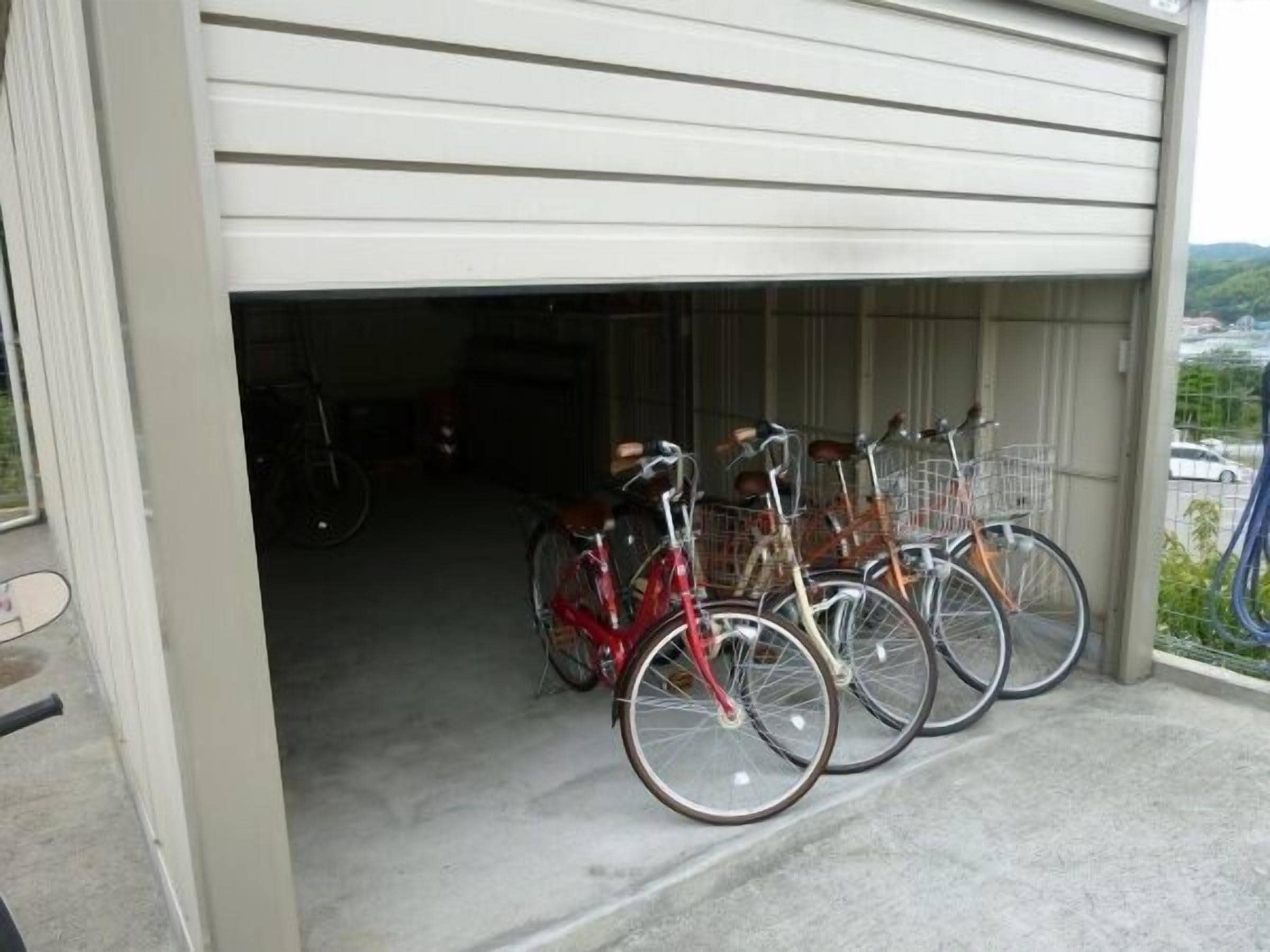 A garage with bicycles parked inside.