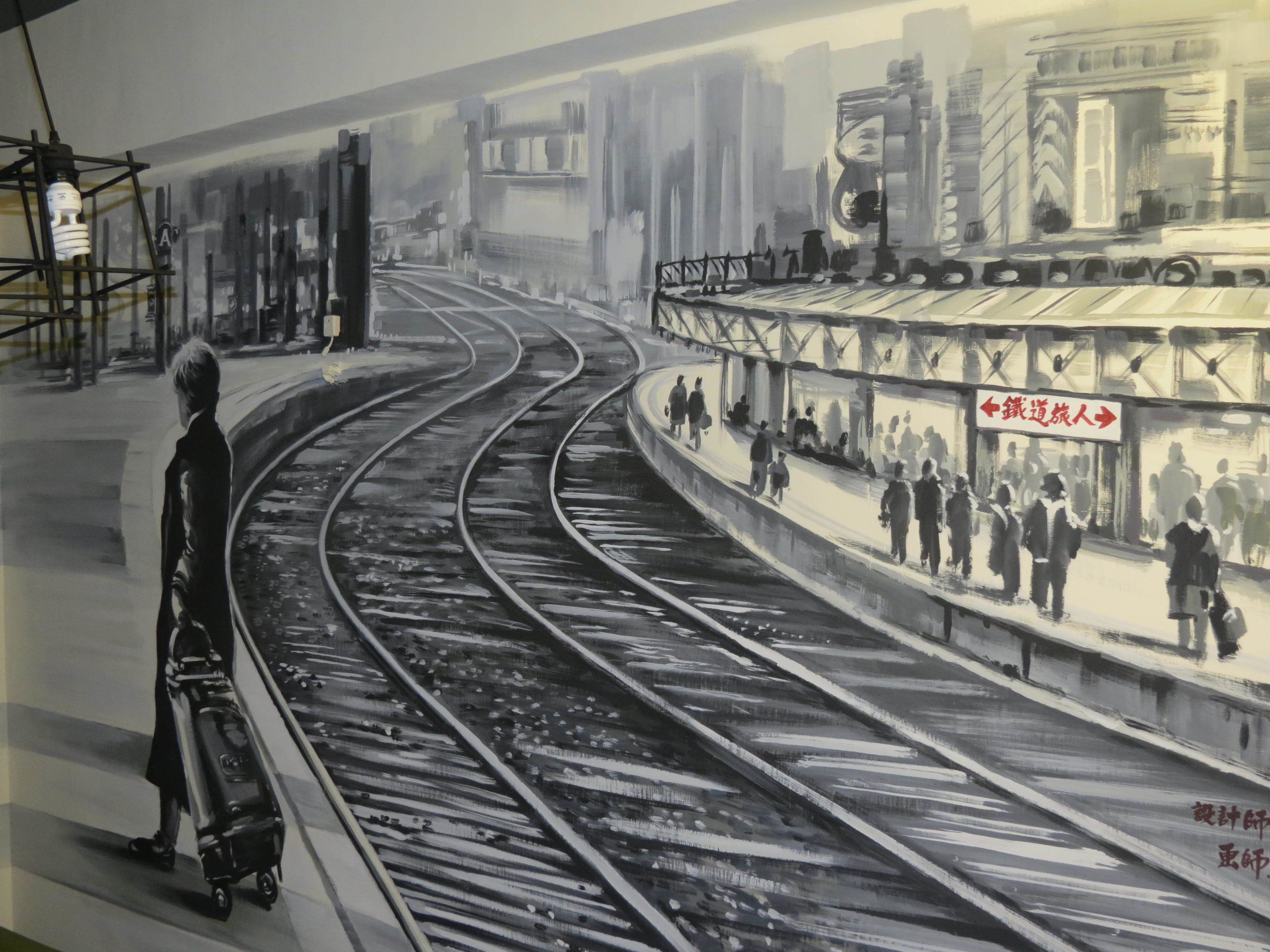 A detailed drawing of a train station with multiple tracks and a platform.