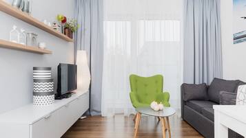 Apartment, 1 Bedroom | Living room | Flat-screen TV