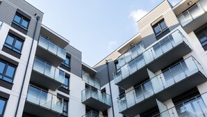A multi-story building with balconies, large windows, and a modern architectural design. - Apartamenty Florek - Morski (Kolobrzeg)