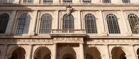 A classical building with multiple arched windows and a central decorative element.