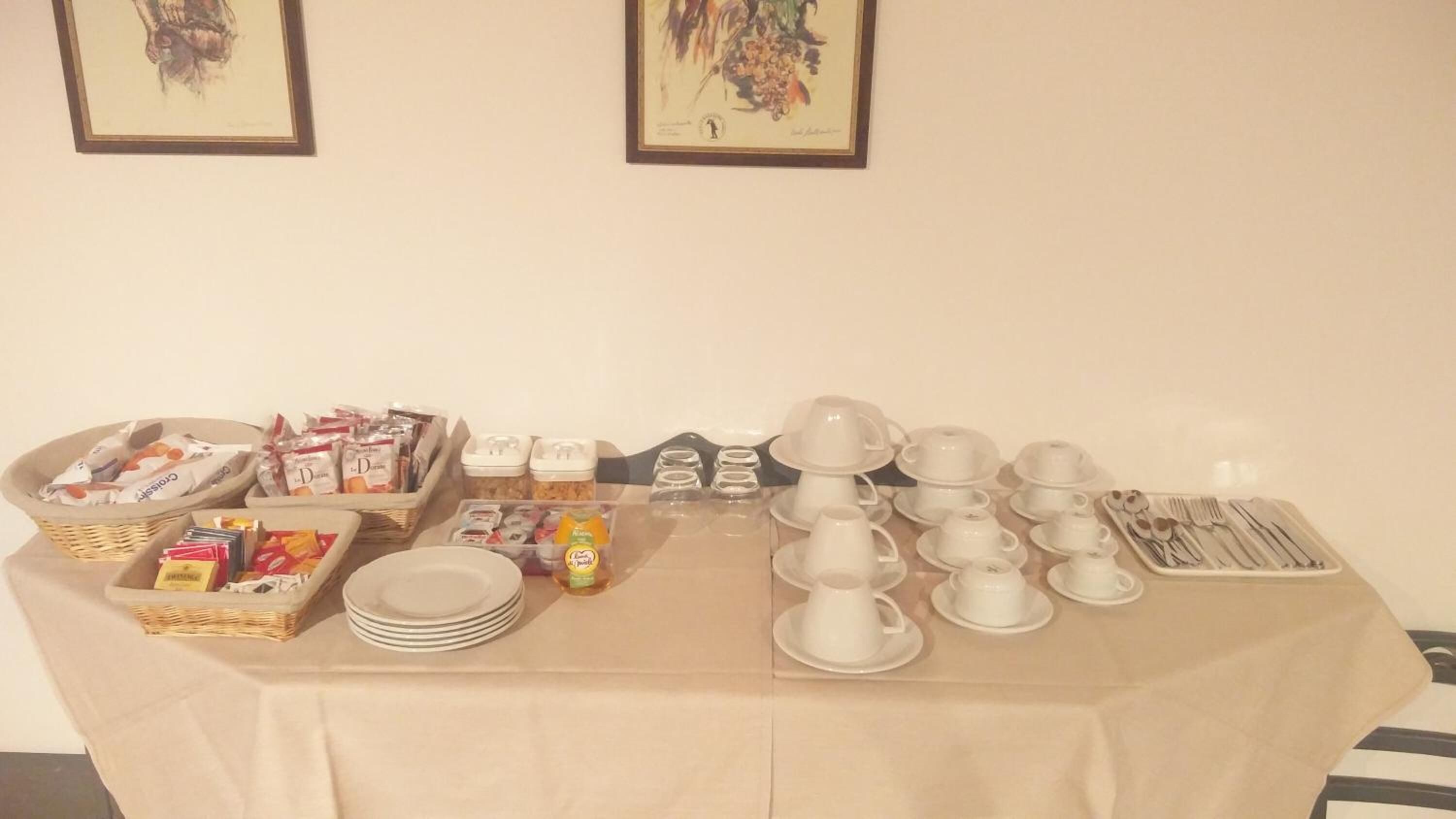 A buffet setup with various food items and dining ware.