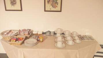 A buffet setup with various food items and dining ware.