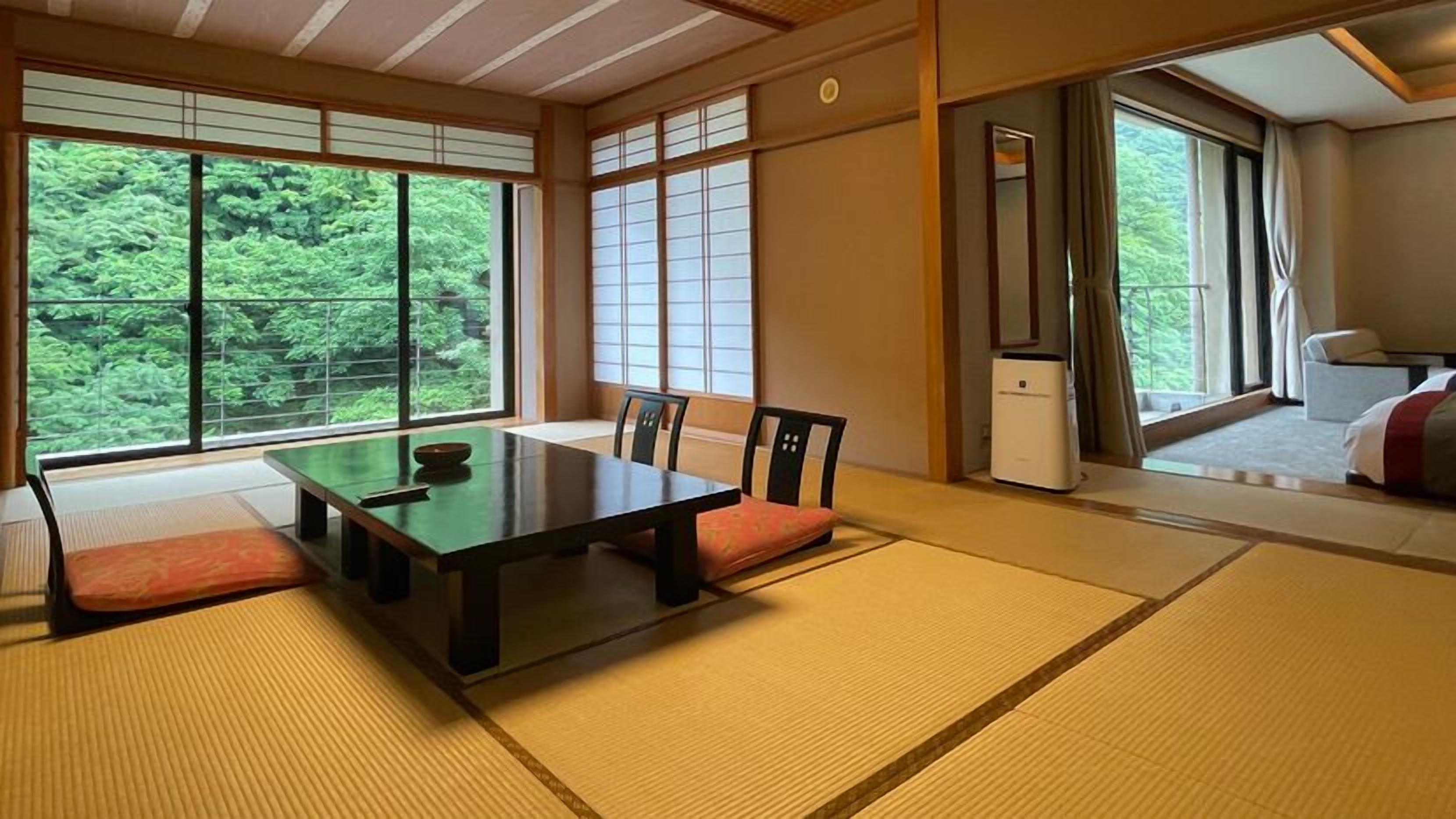 A traditional Japanese room with tatami flooring, a low table, and sliding doors.