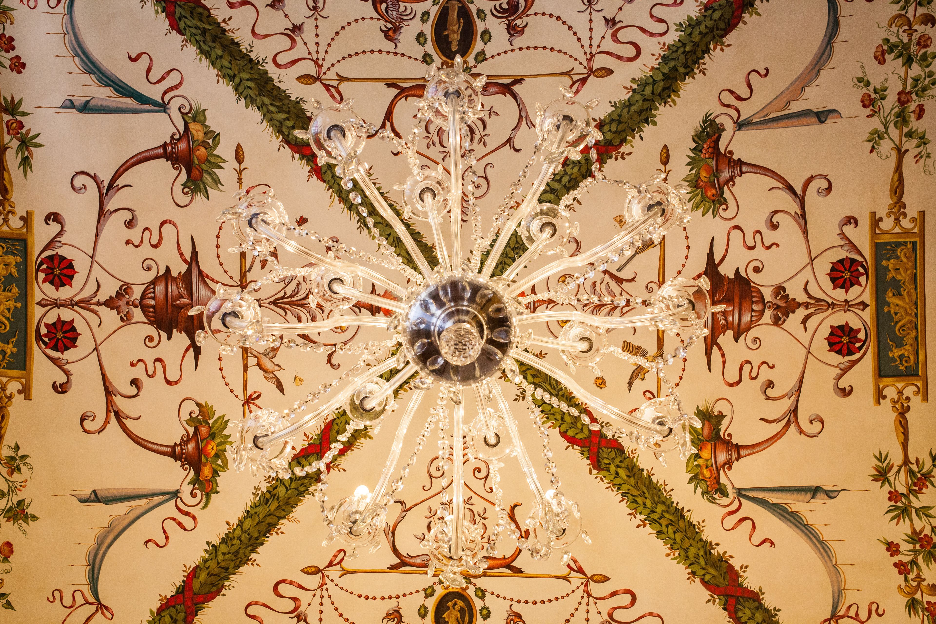 A chandelier with multiple arms and crystal decorations.