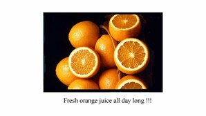 A collection of oranges, some whole and some cut in half, with a caption suggesting the availability of fresh orange juice. - Walter Guest House (Rome)