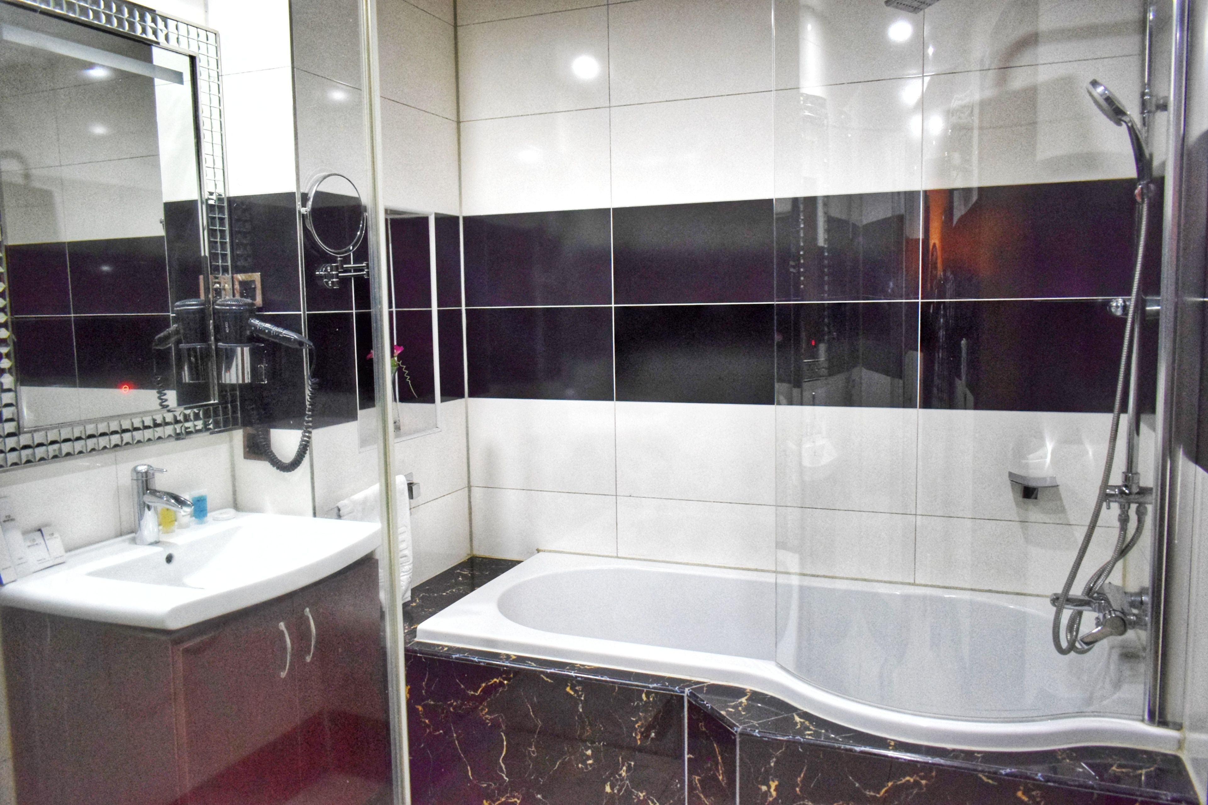 executive room | bathroom | rainfall showerhead, designer toiletries, hair dryer, bathrobes