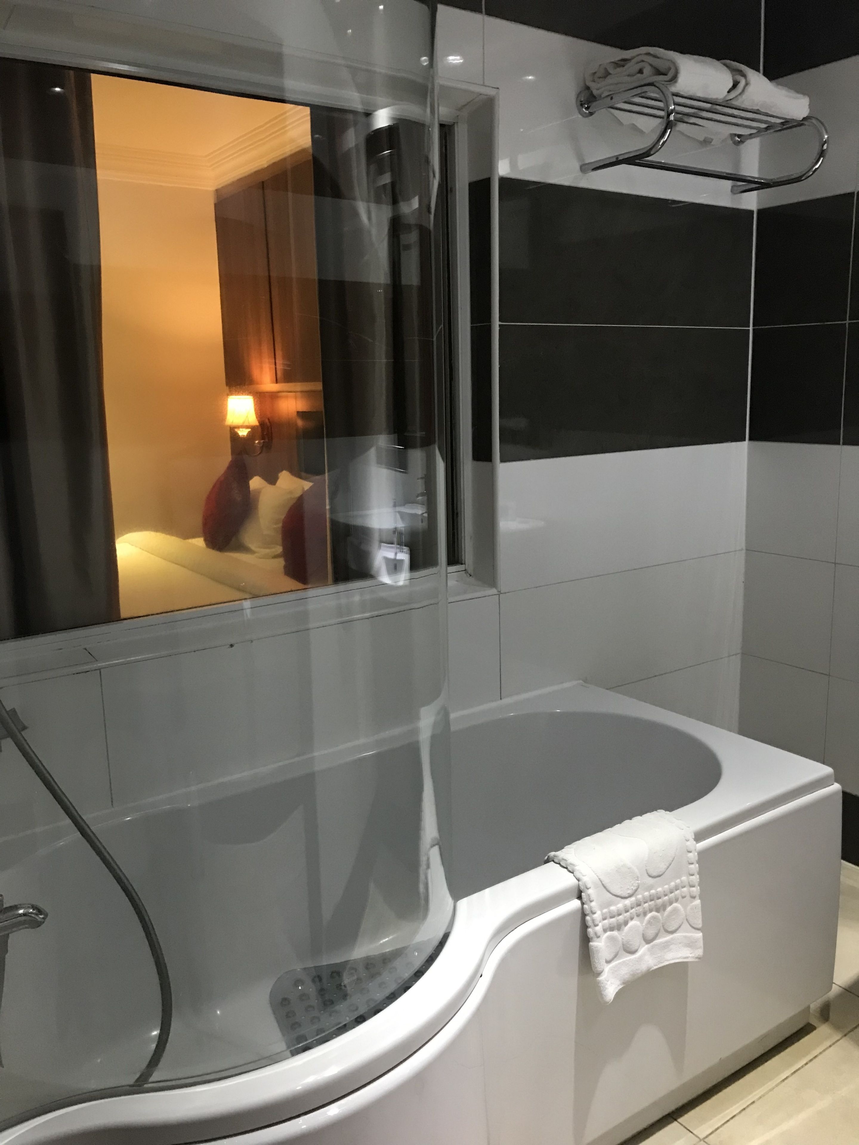 deluxe room | bathroom | rainfall showerhead, designer toiletries, hair dryer, bathrobes