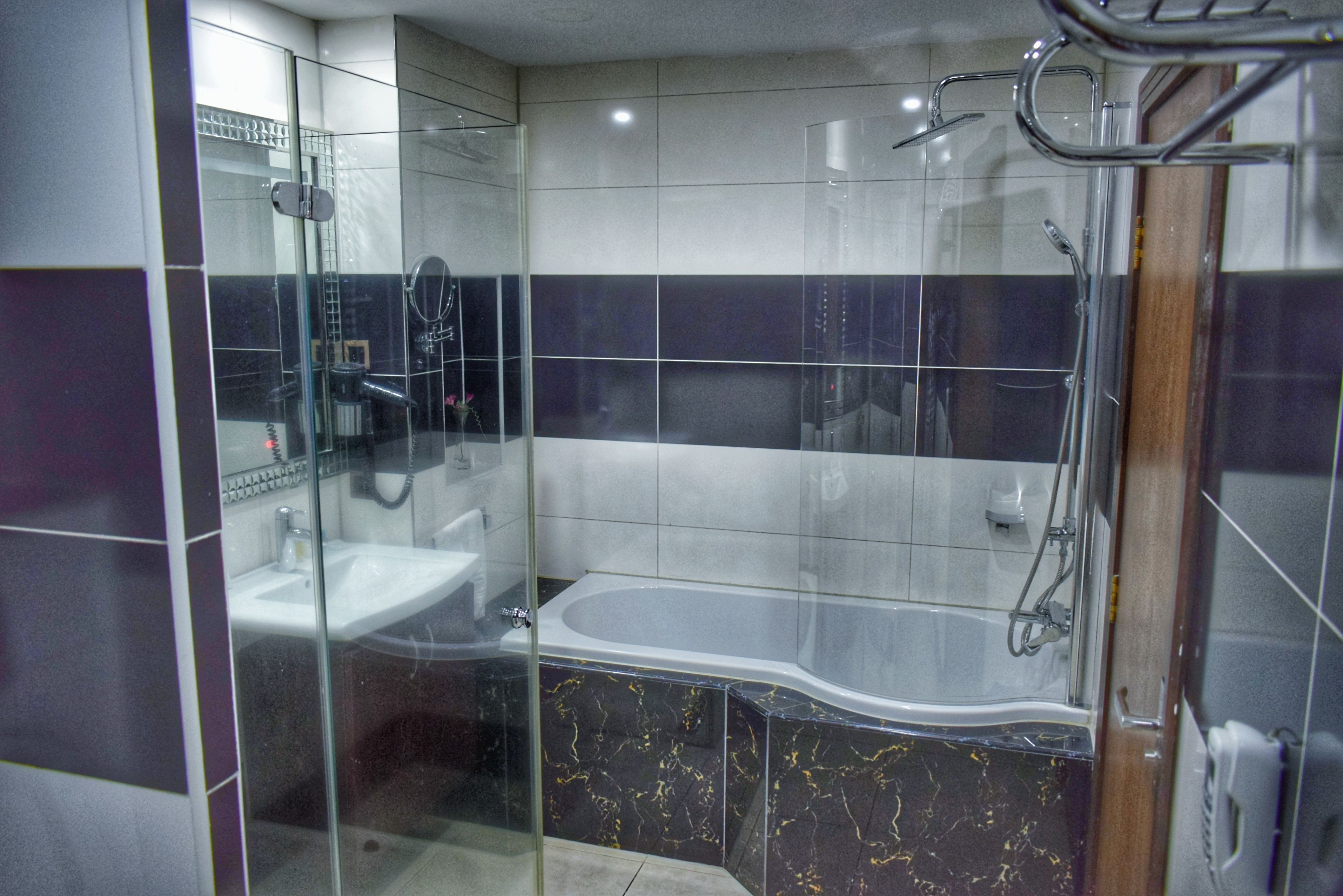 executive suite | bathroom | rainfall showerhead, designer toiletries, hair dryer, bathrobes