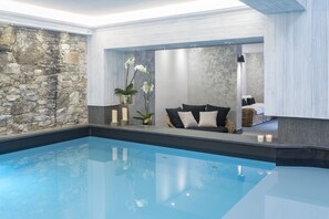 Indoor pool, pool umbrellas, pool loungers