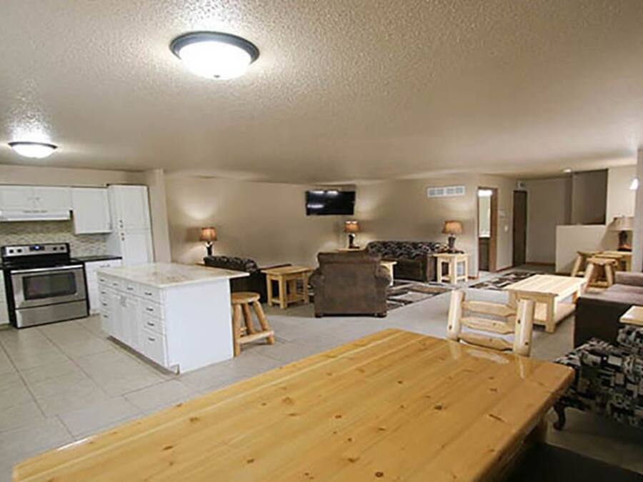 A compact living space with a kitchenette, a dining area, and a seating area with a TV.