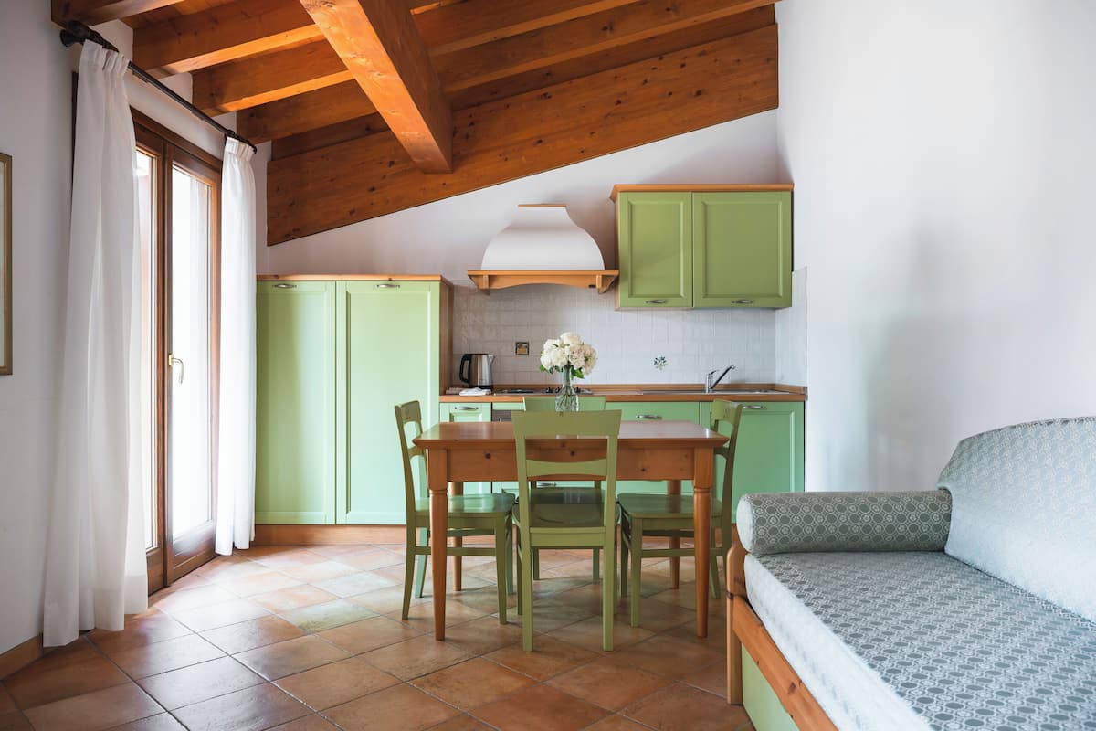 A cozy kitchen with a dining table, chairs, and a built-in bench.