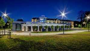 A modern hotel with a glass facade, a sign reading "HOTEL LOFT 1898," and a well-lit entrance. - Hotel Loft 1898 (Suwalki)