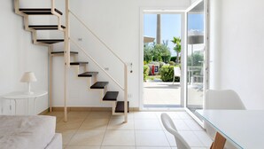 A modern interior with a staircase, a dining area, and a view of the outside. - Tonnara di Sciacca (Sciacca)