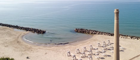 Playa privada, playa de arena blanca, camastros y sombrillas