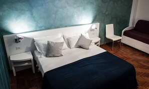 Habitación cuádruple | Ropa de cama de alta calidad y minibar 