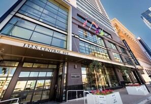A hotel with a modern facade, large windows, and flags. - Residence Inn Phoenix Downtown (Phoenix)