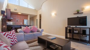 A modern living room with a sofa, coffee table, and entertainment unit.