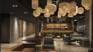 A modern lounge area with seating and a bar.