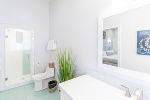 A bathroom with a toilet, bidet, and sink. - The Newport Lofts - 359 Thames Street (Newport)