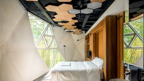 A modern bedroom with a geometric ceiling design, a large window, and a wooden wardrobe. - Planet Zero Retreat (Huzhou)