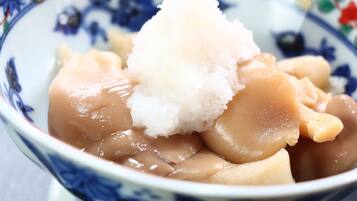 A bowl of food with a white topping, possibly ice cream or shaved ice, and a blue and white patterned bowl.