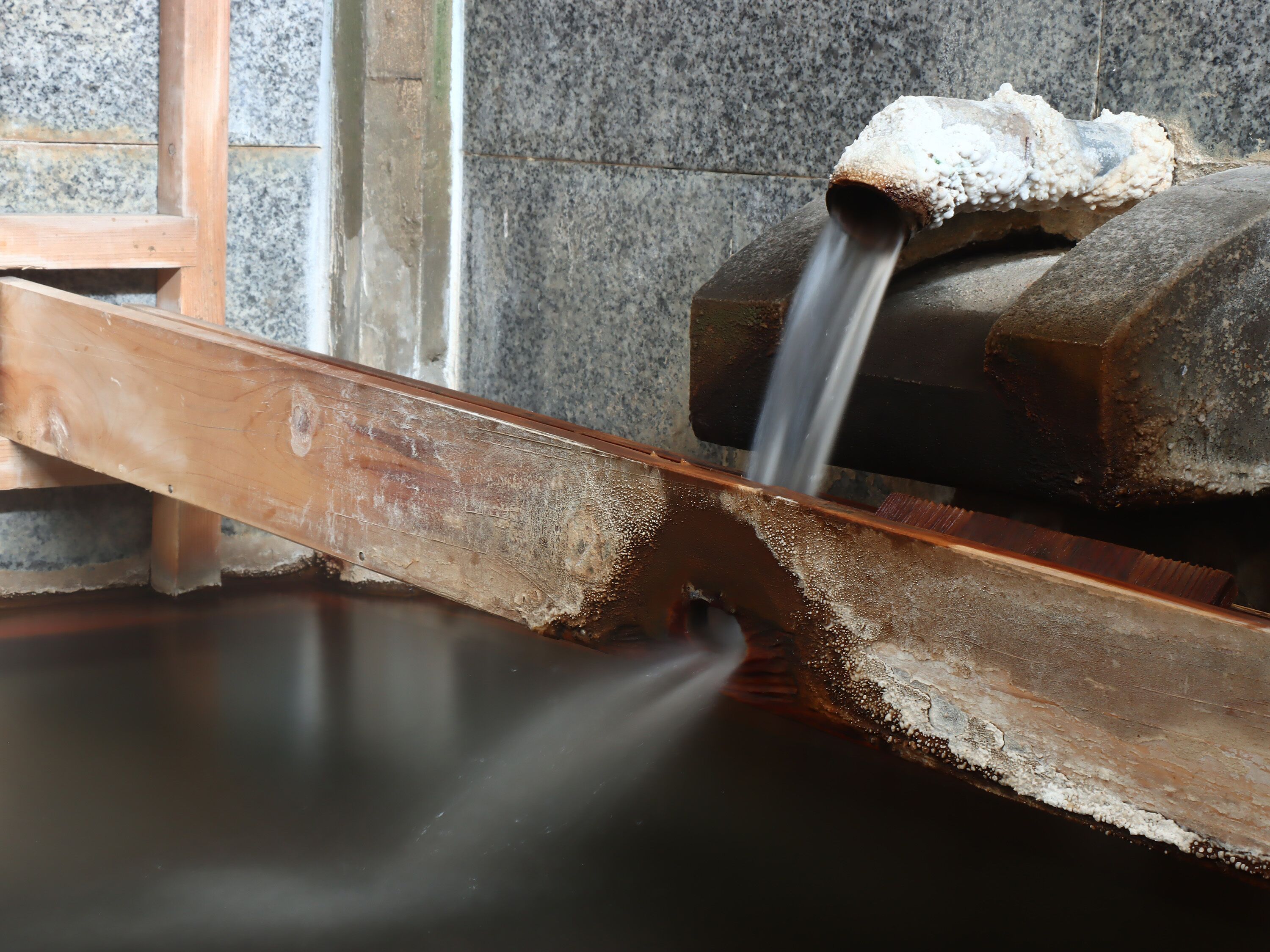 A metal structure with a flowing water feature.