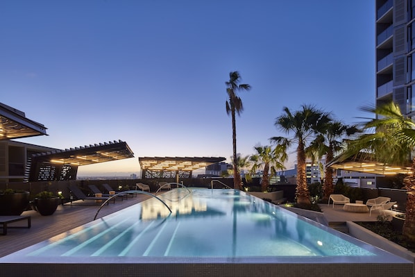 Outdoor pool, open 6:00 AM to 10:00 PM, pool loungers