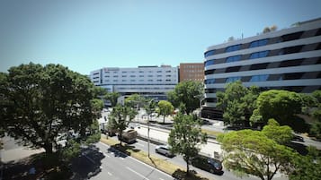 A multi-story building with a modern architectural design, featuring a mix of white and dark facade elements.