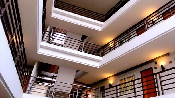 A multi-level atrium with balconies, railings, and a central open space. - Room Riverside (Chiang Mai)