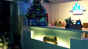 A reception desk with a Christmas tree and a 'Merry Christmas' sign. - Pitikant Place (Lam Luk Ka)