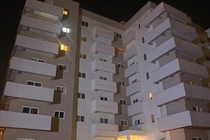 A multi-story building with balconies and windows.