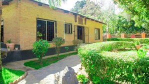 A brick building with a paved pathway leading to a door.