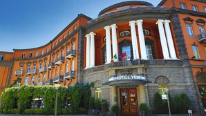 A historic building with a classical facade, columns, and a balcony. - Grand Hotel Yerevan (Yerevan)