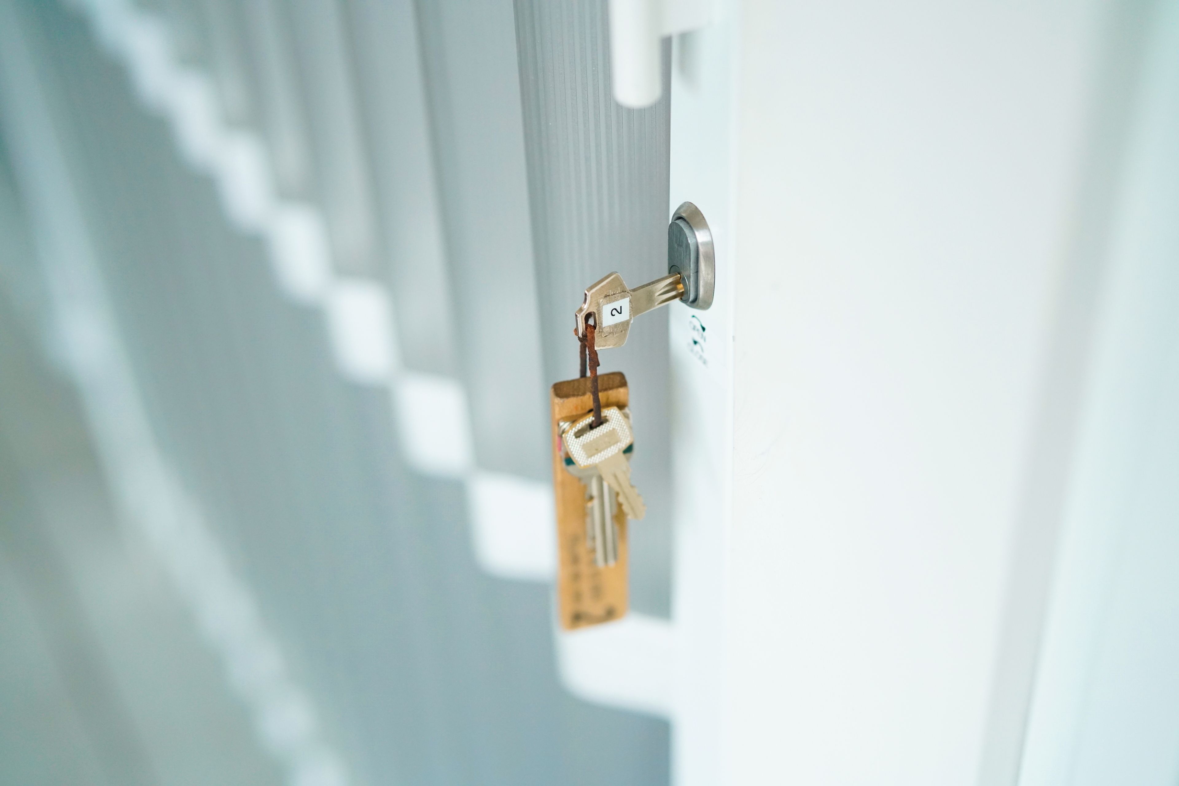 A door with a keyhole and a key inserted.