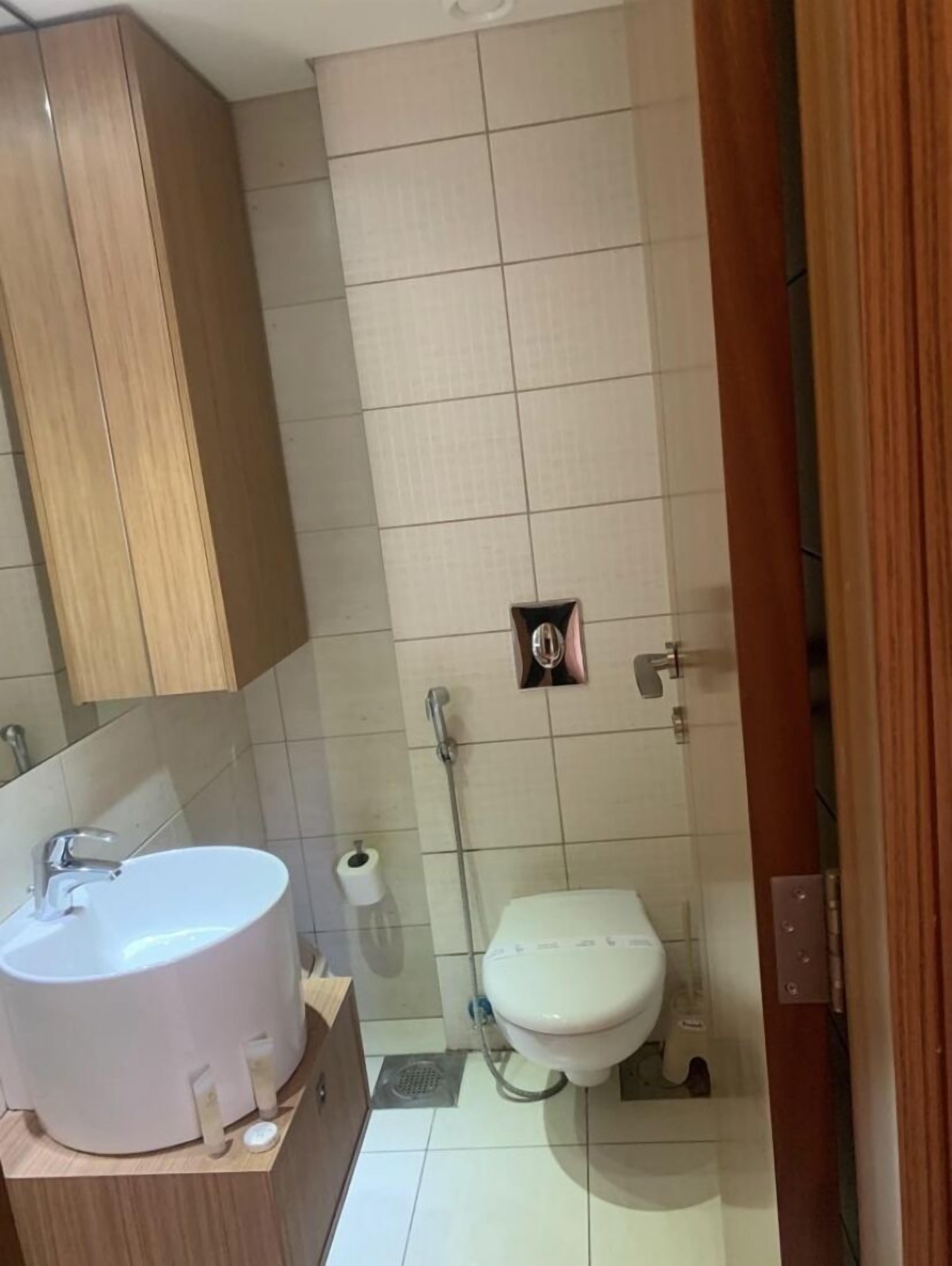 A bathroom with a sink, toilet, and shower.