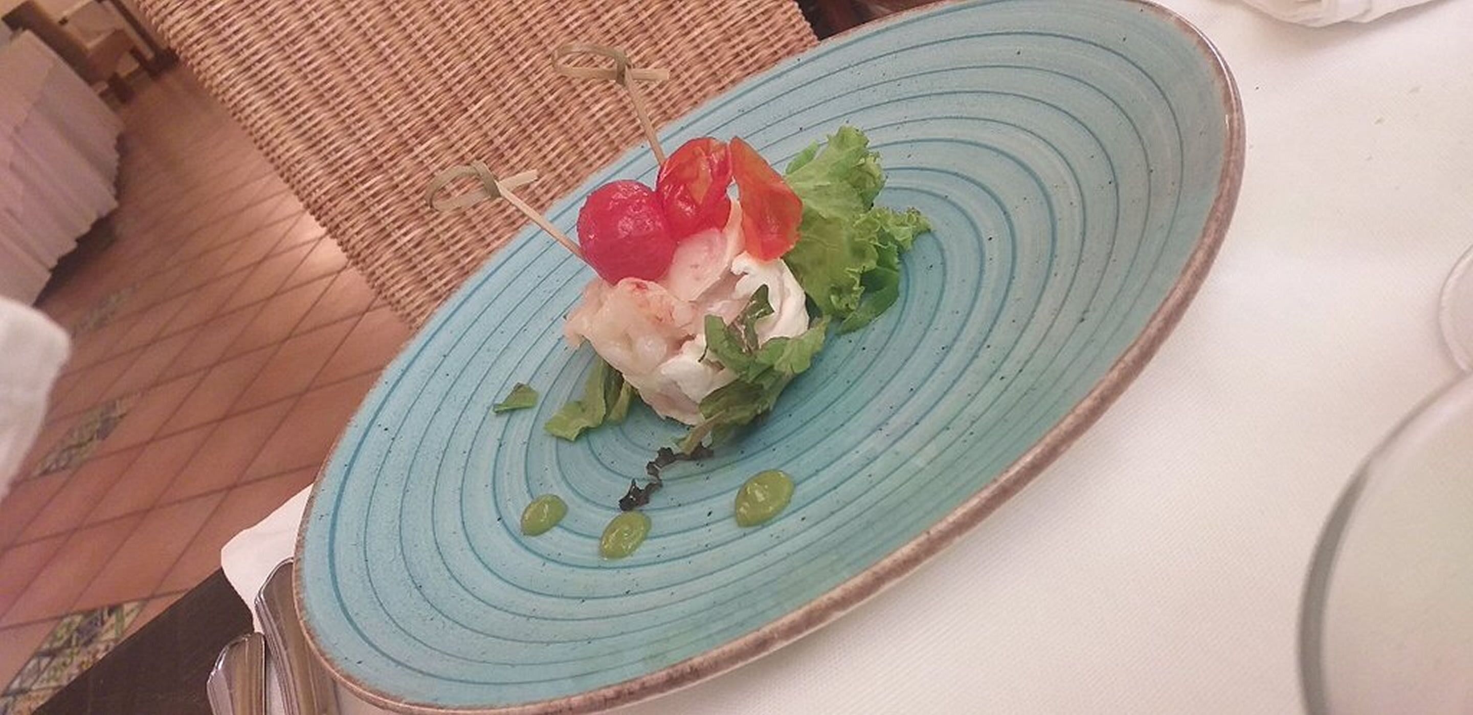 A plate with a salad on a blue plate.