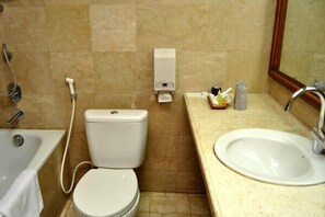 A bathroom with a toilet, sink, and shower. - Mutiara Hotel Cilacap (Cilacap)