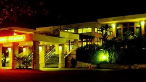 A hotel with a well-lit entrance, a visible staircase, and a signboard. - Mutiara Hotel Cilacap (Cilacap)