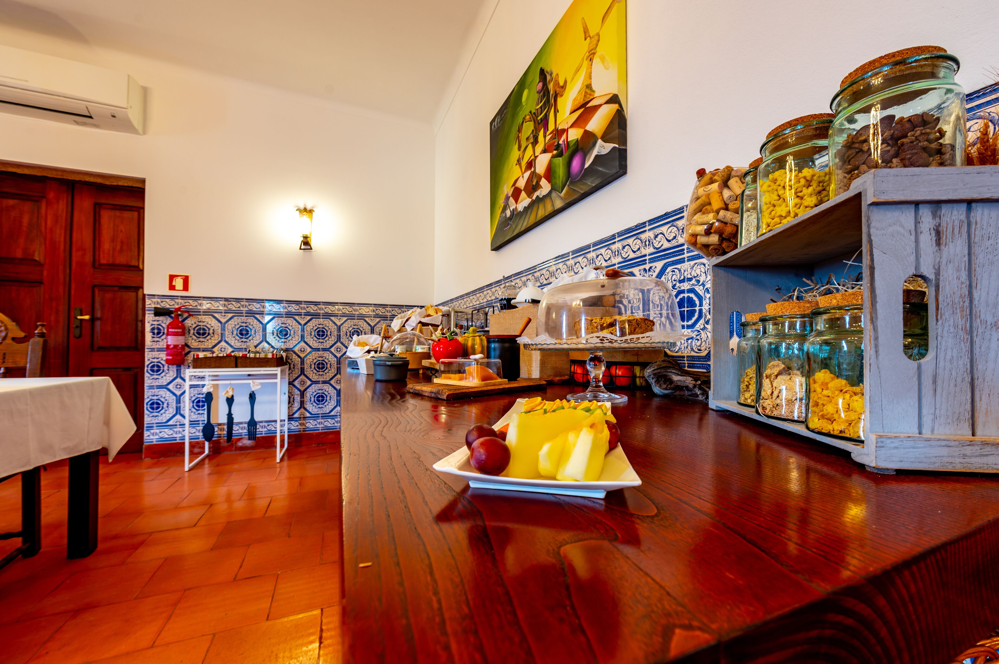 A kitchen with a wooden countertop, a white table, and a tiled backsplash.