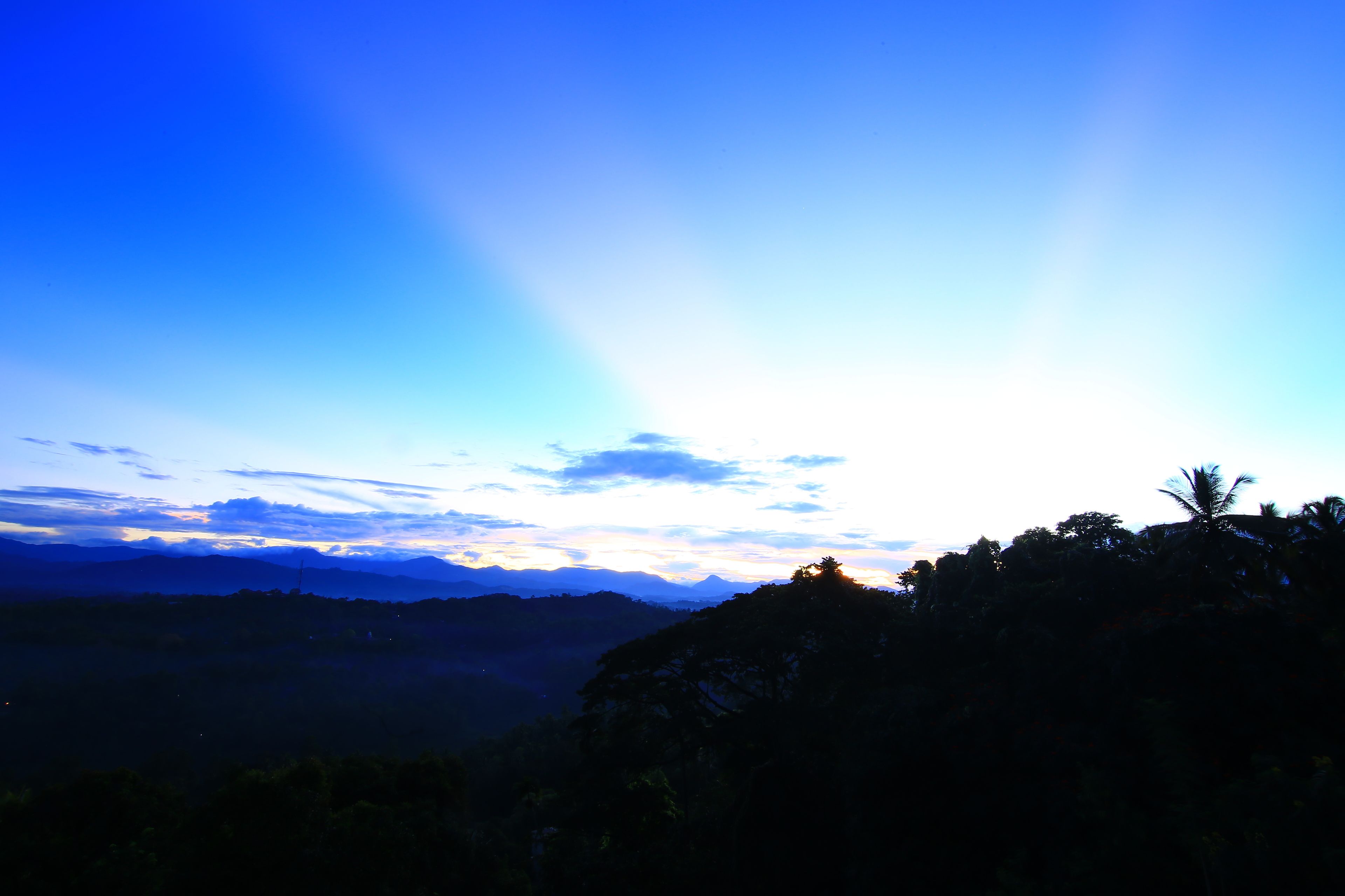 A mountainous landscape with a clear sky and distant mountains.