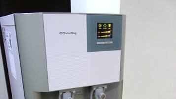 A water dispenser with a control panel and two drink dispensers.
