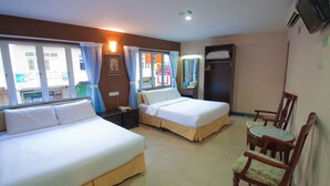 A hotel room with two beds, a dining table with chairs, and a TV. - CK Hotel (Malacca City)