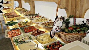 A buffet with various dishes and a decorative wooden structure.