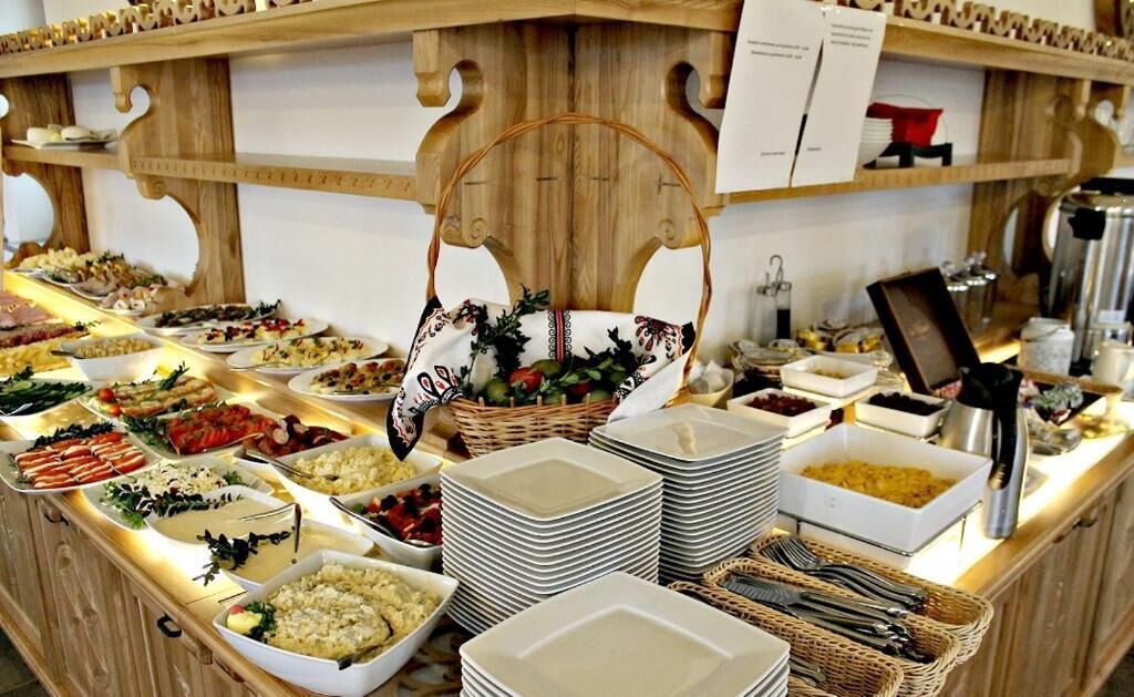 A buffet setup with various food items and a central basket.
