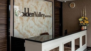 A reception desk with a marble top and a large sign reading "Golden Valley Hotel". - Golden Valley Hotel (Malacca City)