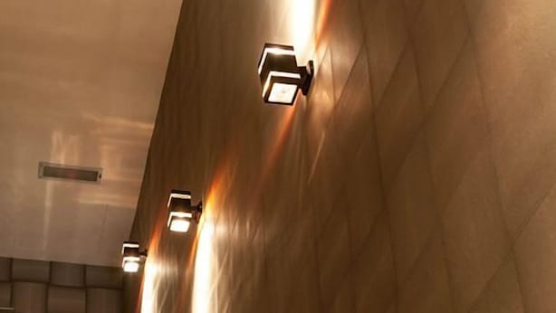 A modern interior with a staircase and wall-mounted lighting. - Golden Valley Hotel (Malacca City)