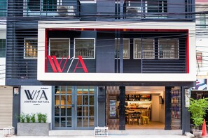 A modern building with a prominent 'W/A' sign, large windows, and a visible entrance.